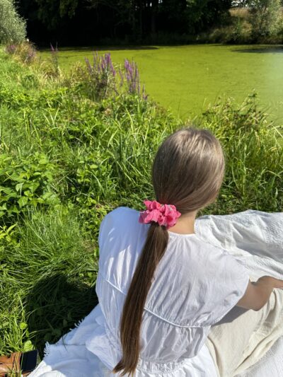 Ručně šitá scrunchie rosy star ve vlasech, zapletený cop, přírodní materiál, styling v přírodě.